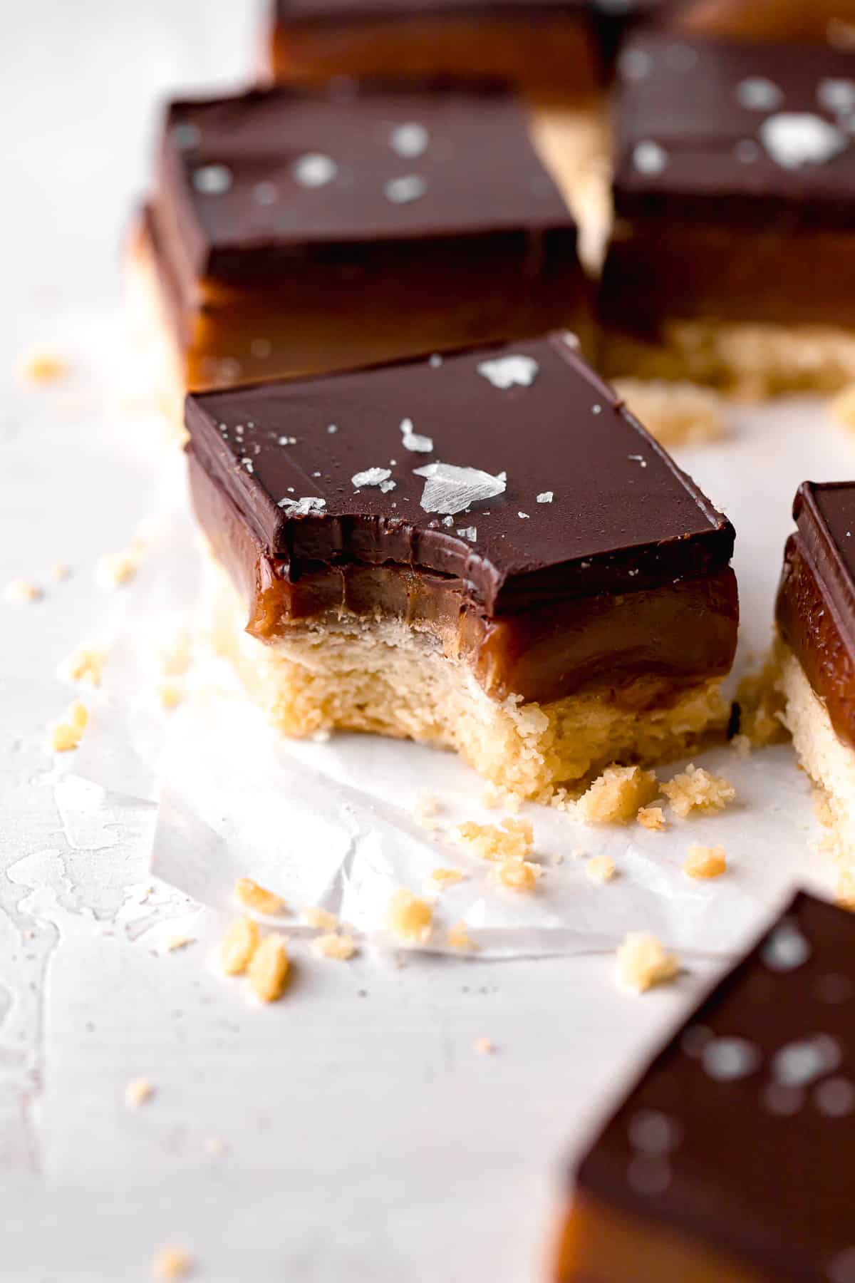 tahini caramel millionaire's shortbread on parchment paper.