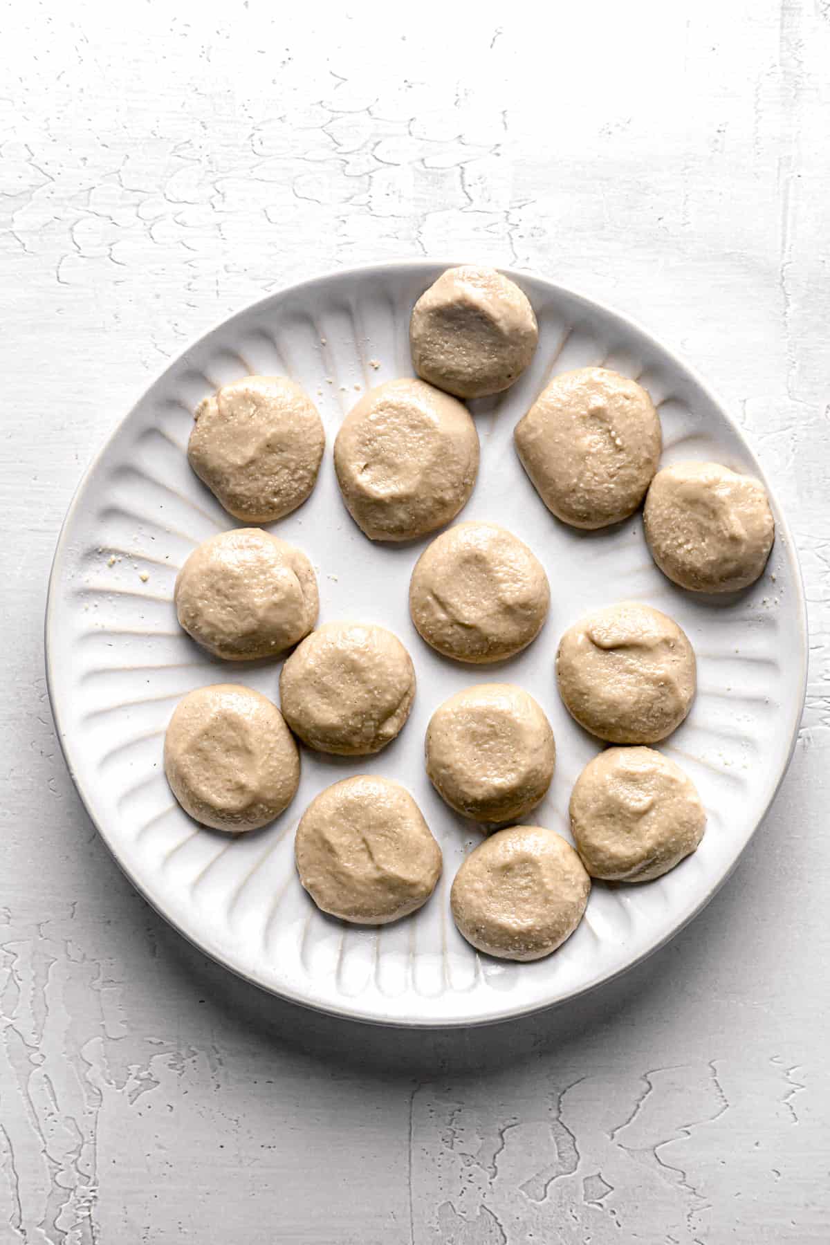 tahini filling shaped into disks on white plate.