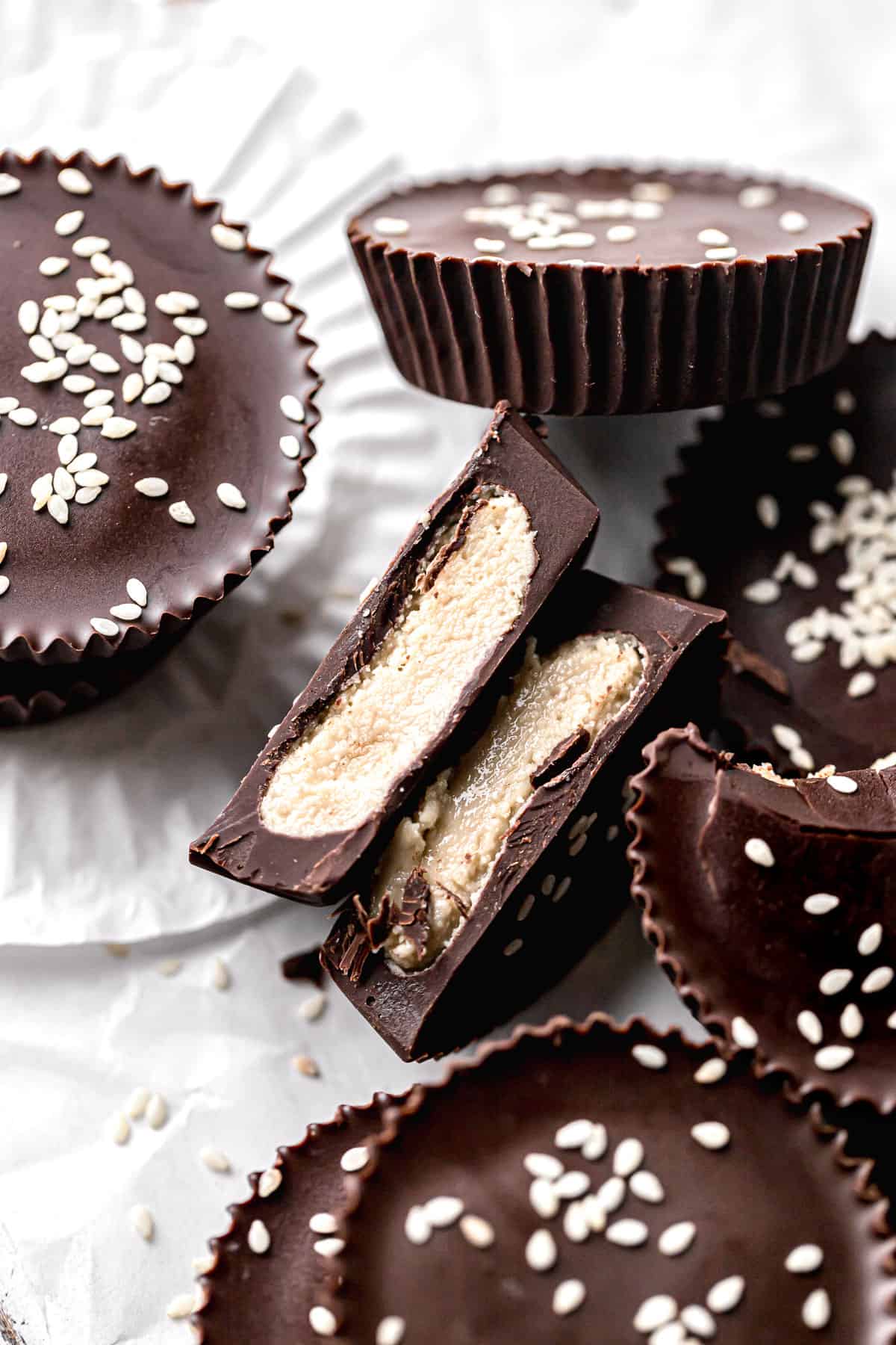 dark chocolate tahini cups cut in half to show center.