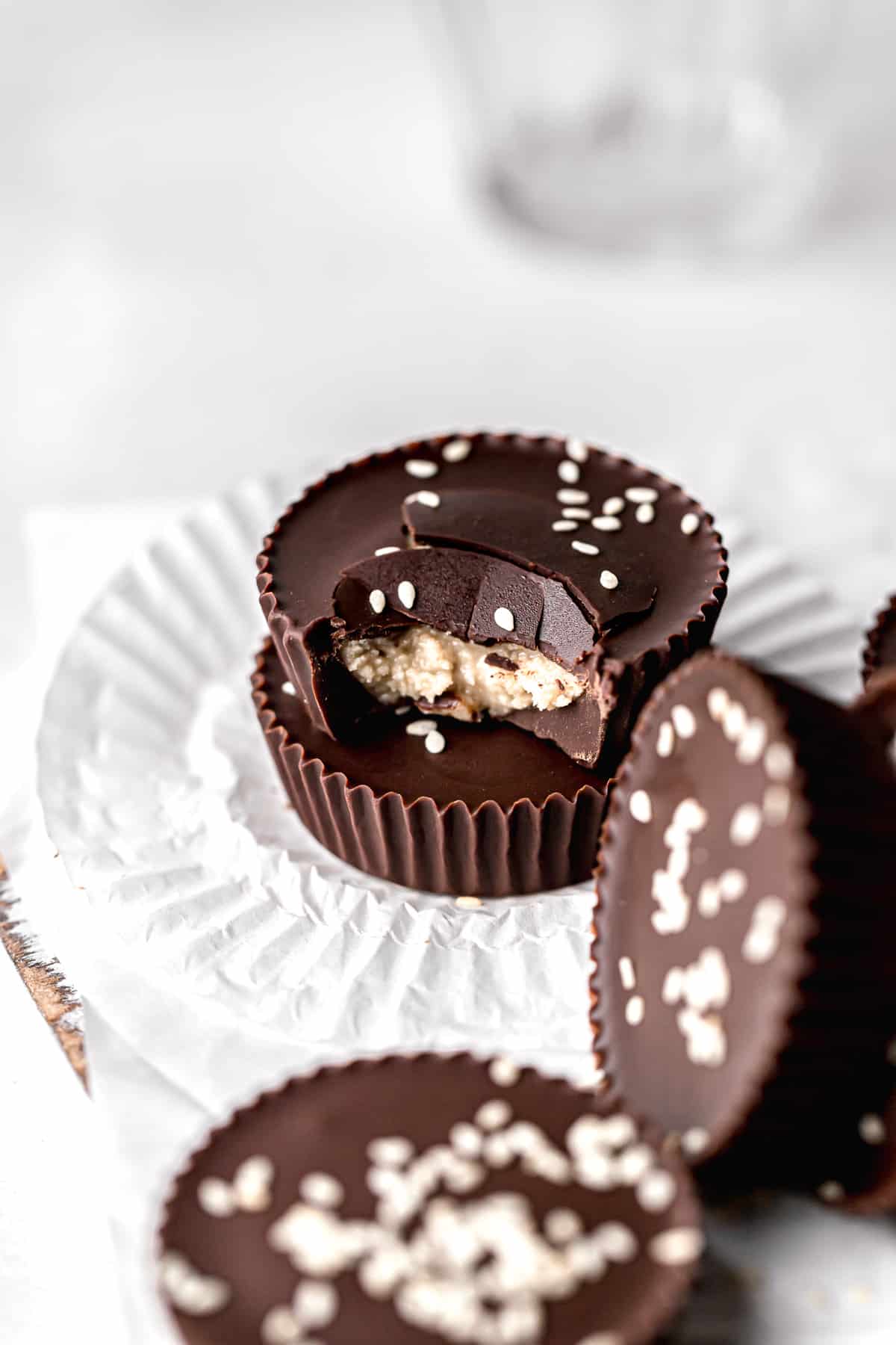 stacked chocolate tahini cups with bite taken out of top one