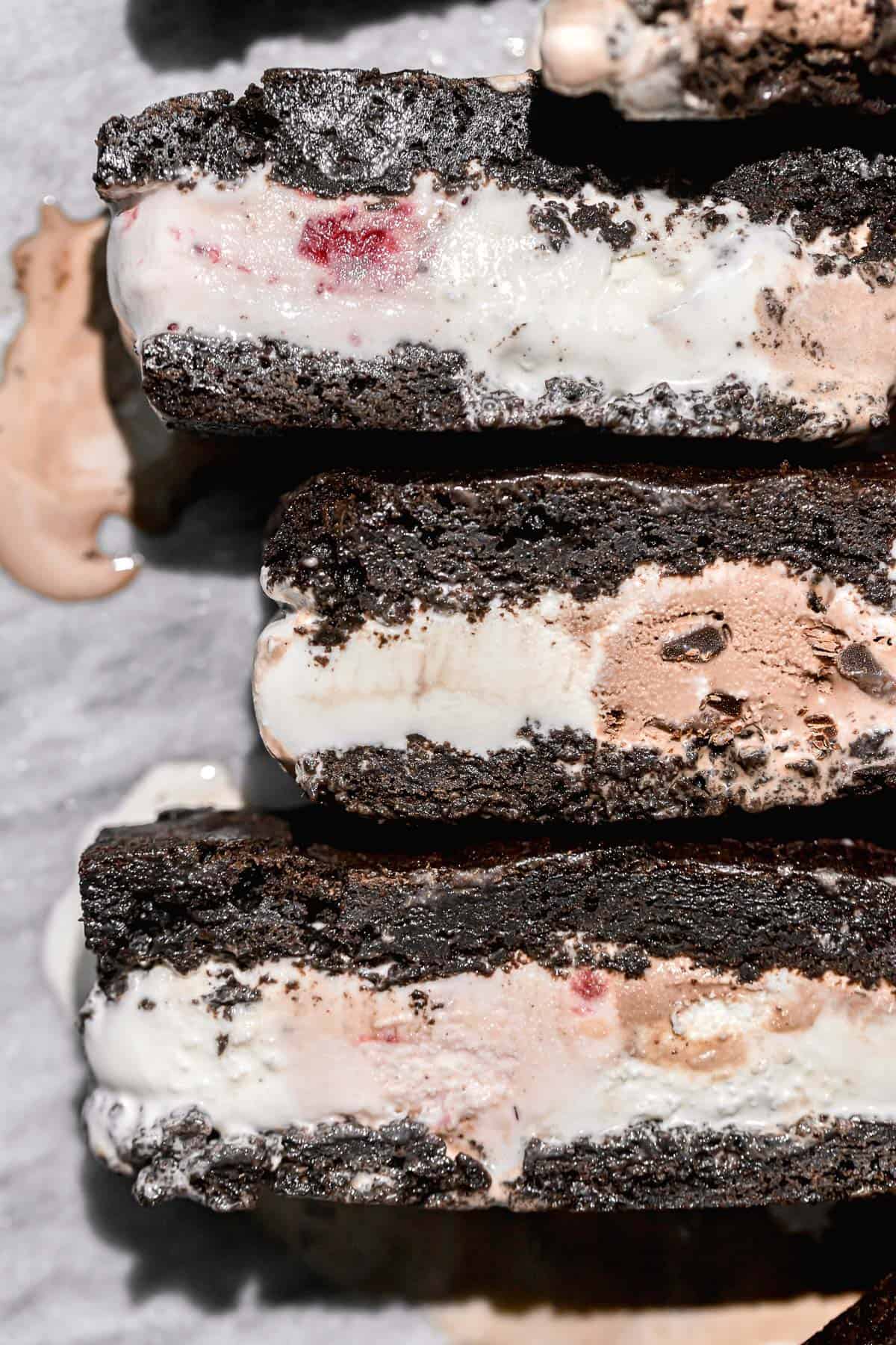 gluten free ice cream sandwiches lined up on marble counter.
