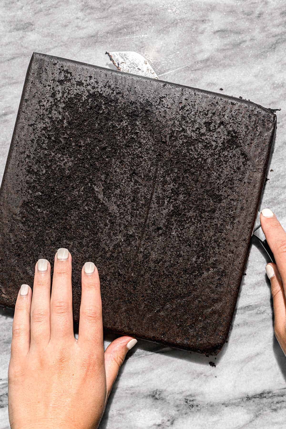 gluten free brownies being cut into two layers.