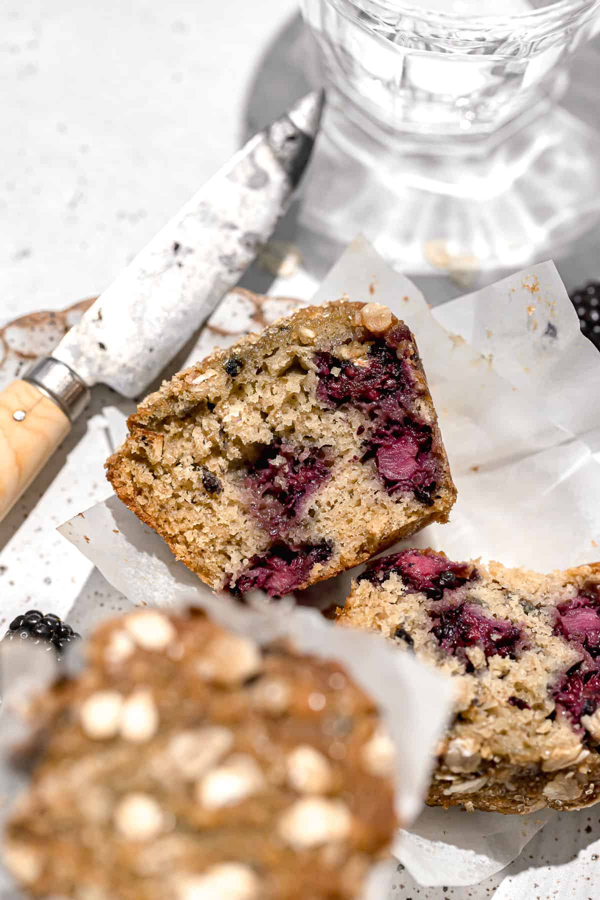 close up of blackberry oatmeal muffin on plate