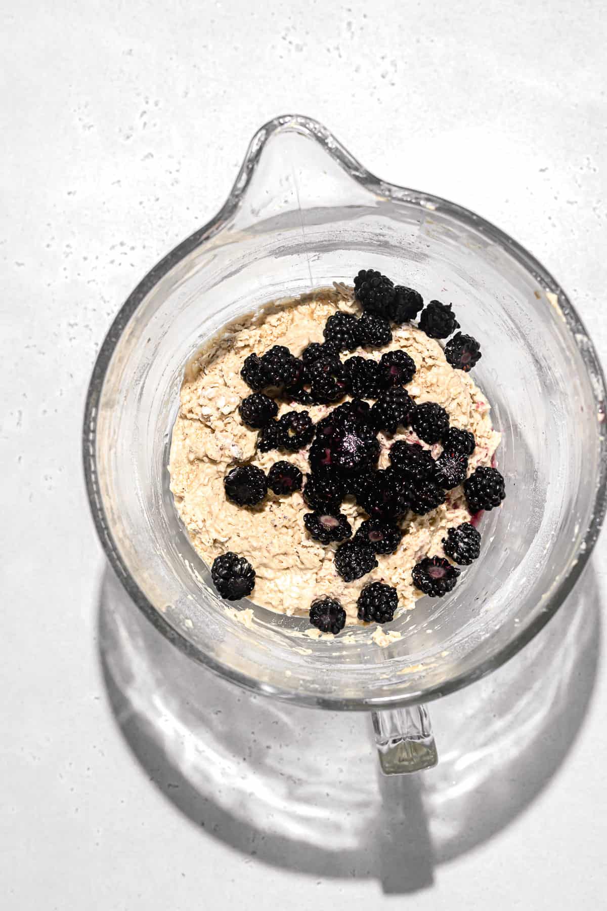 muffin batter in glass mixing bowl.