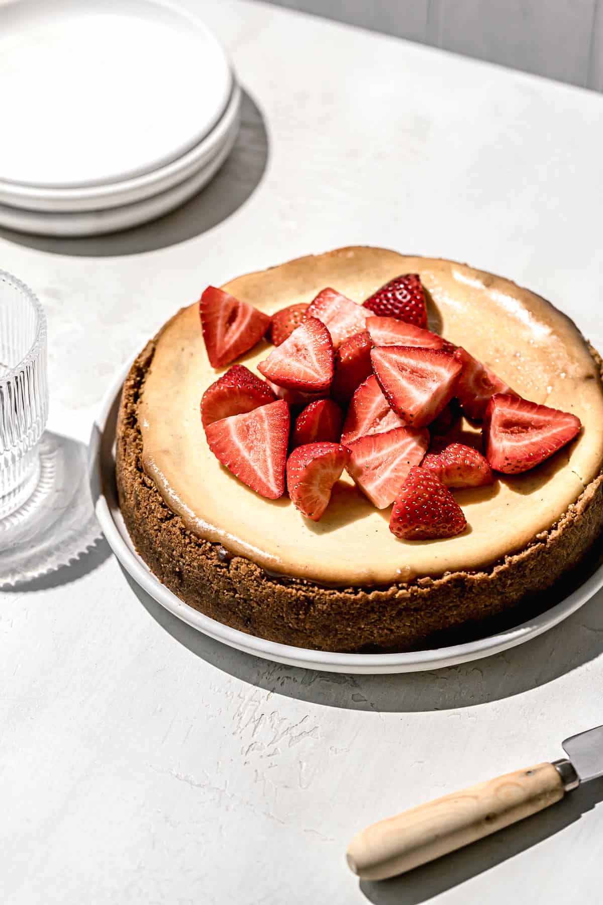 sicilian cheesecake with strawberries on white plate.