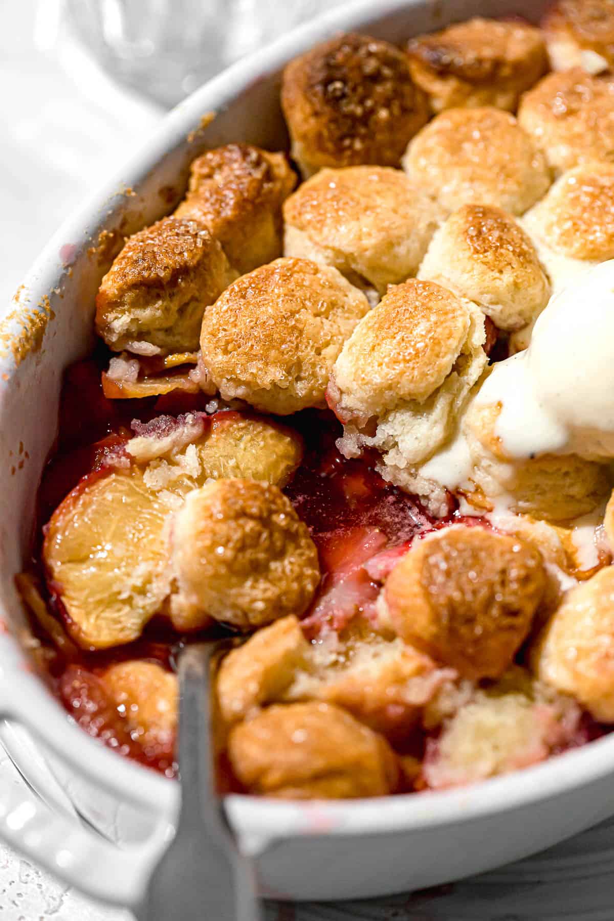 spoon in cobbler revealing filling.