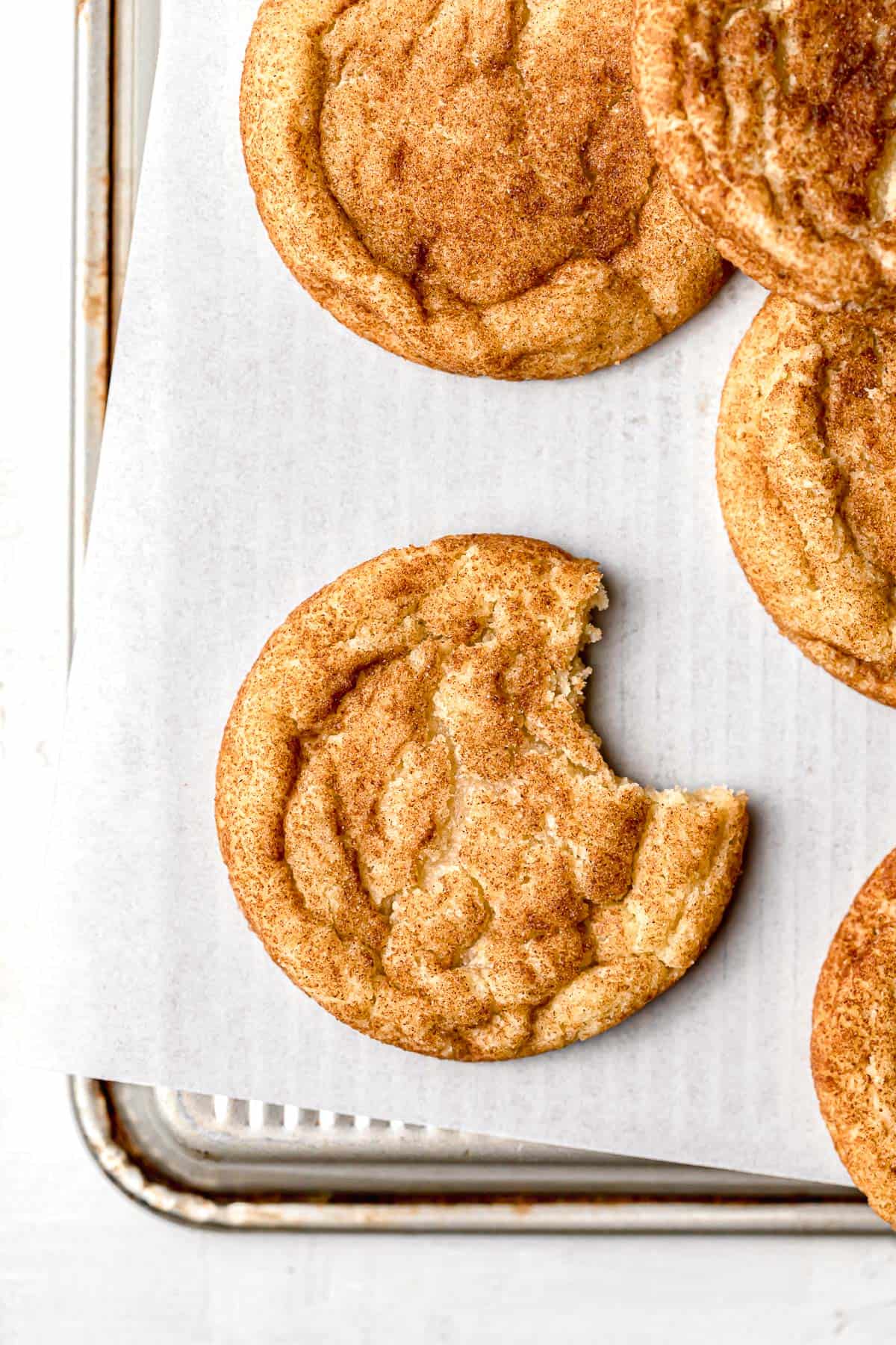 brown butter snickerdoodles without cream of tartar on parchment lined baking sheet.