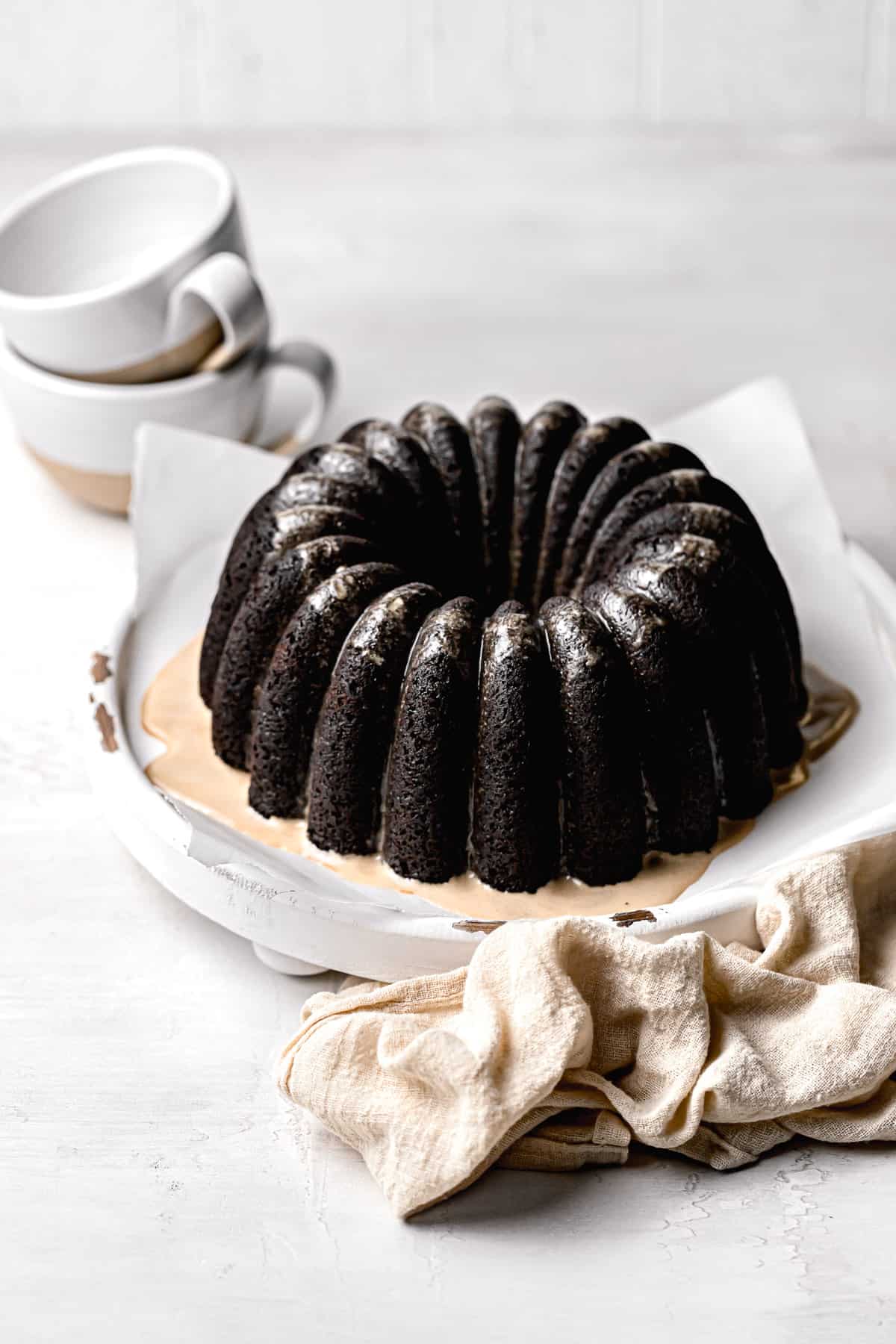 chocolate espresso bundt cake on parchment lined wooden board