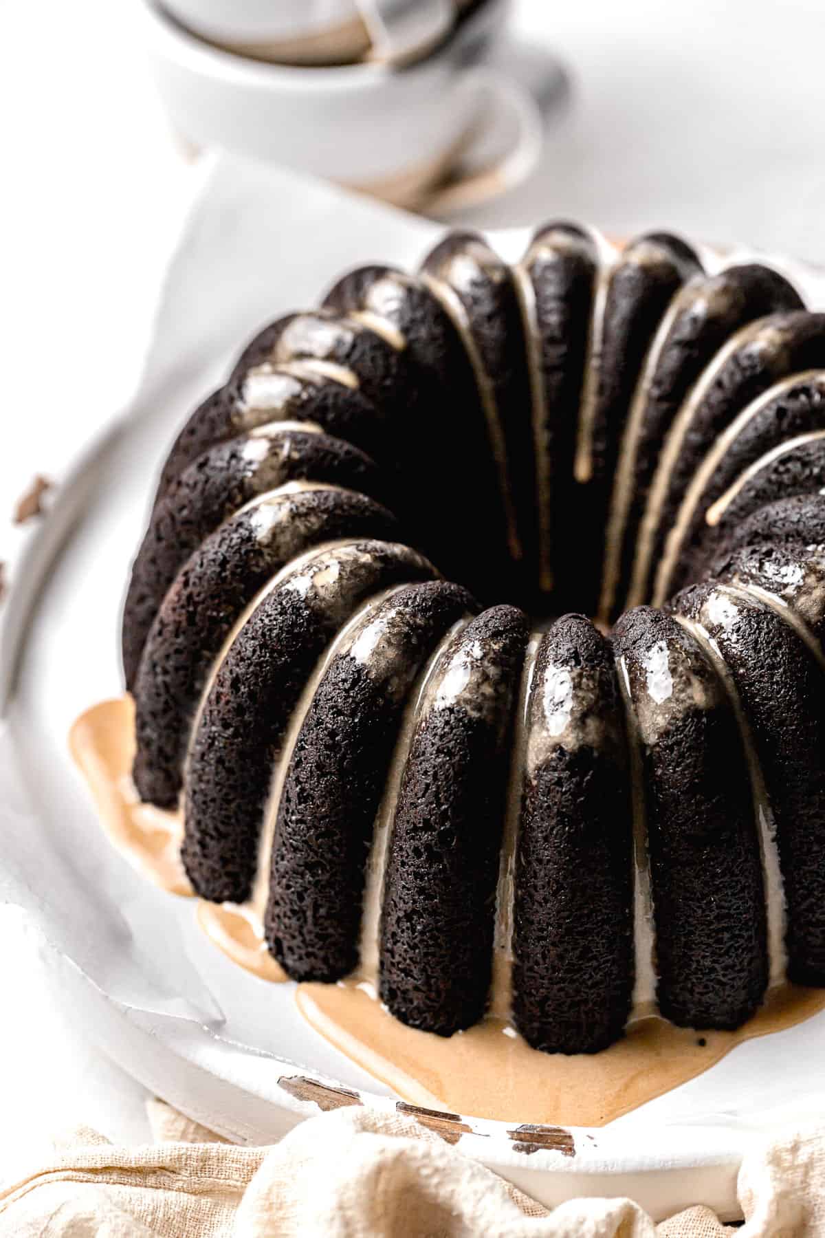 chocolate espresso bundt cake on parchment lined wooden board.