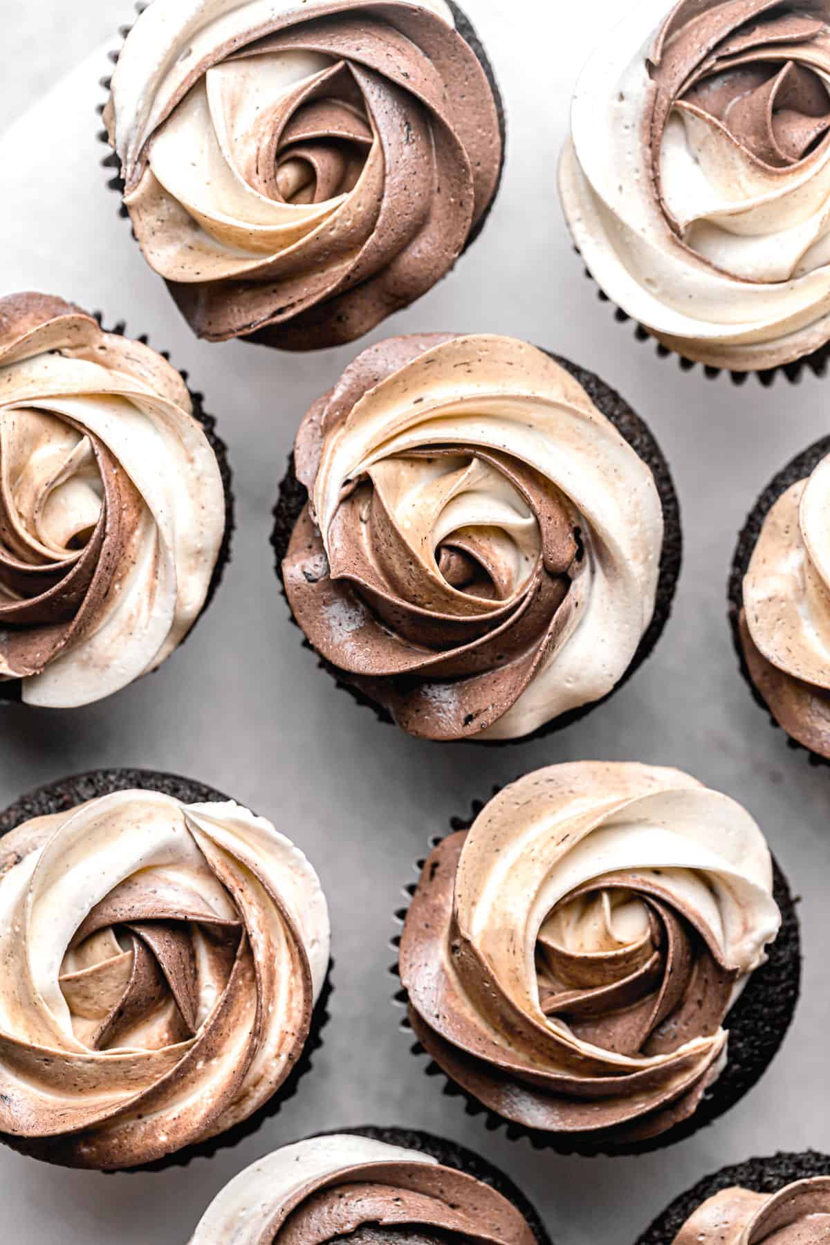 gluten free chocolate cupcakes with swirled buttercream lined up.