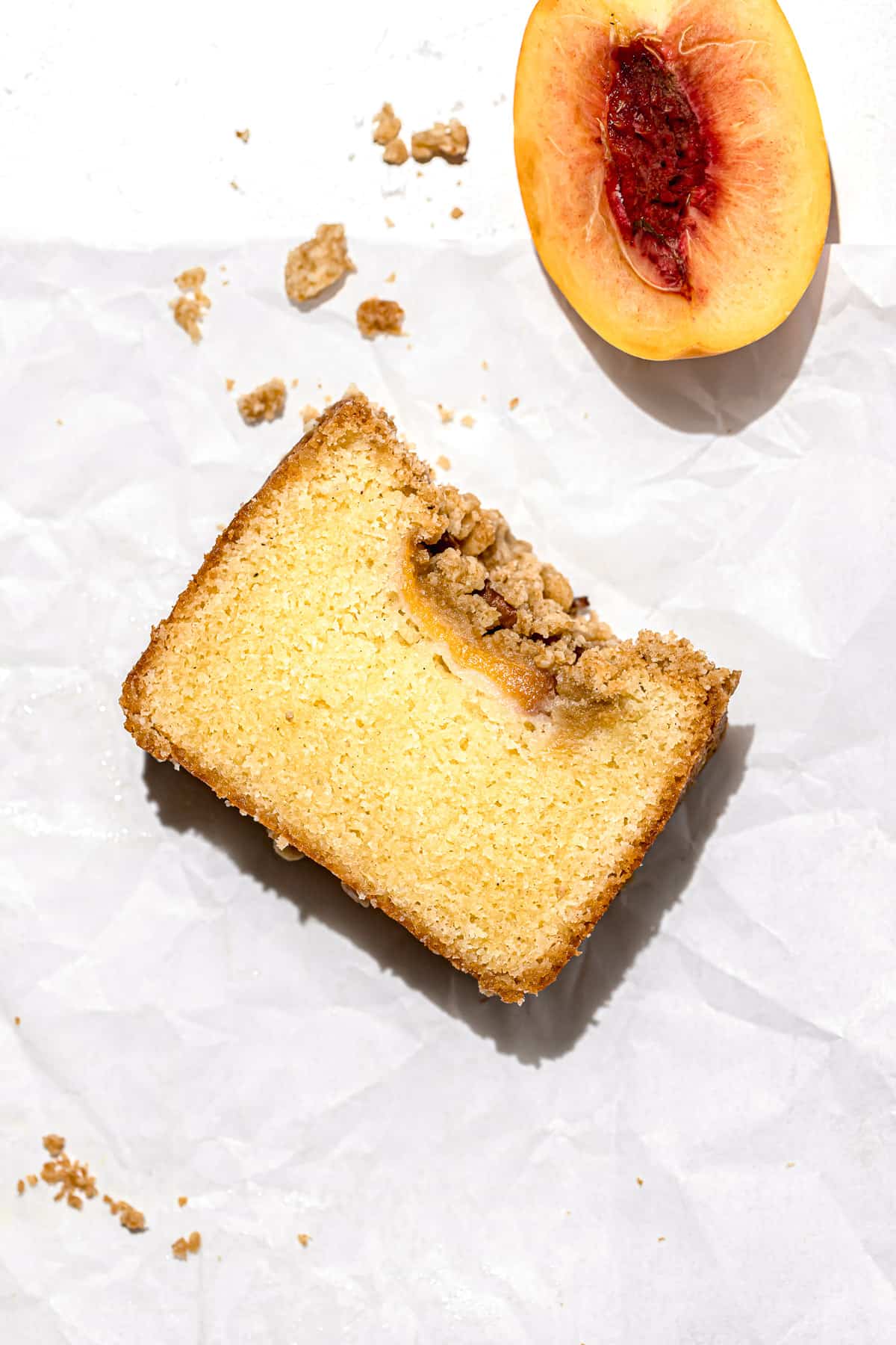 one slice of peach cobbler pound cake on parchment paper