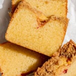 peach cobbler pound cake slices stacked on plate.
