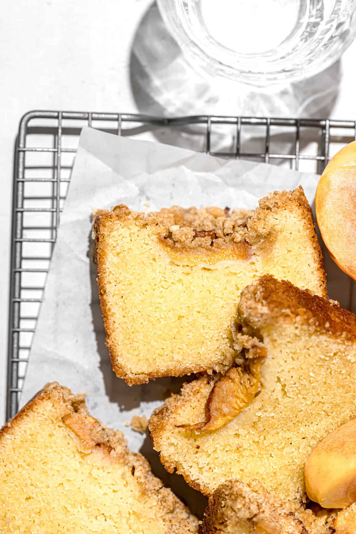 peach cobbler pound cake slices piled on wire rack