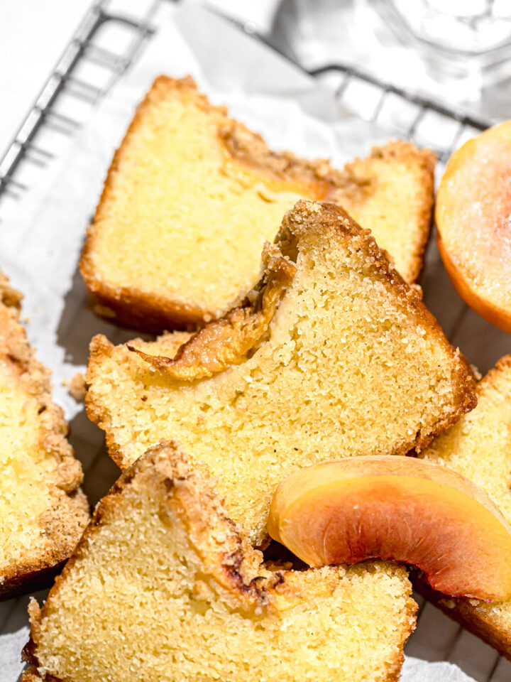 peach cobbler pound cake slices on parchment lined wire rack