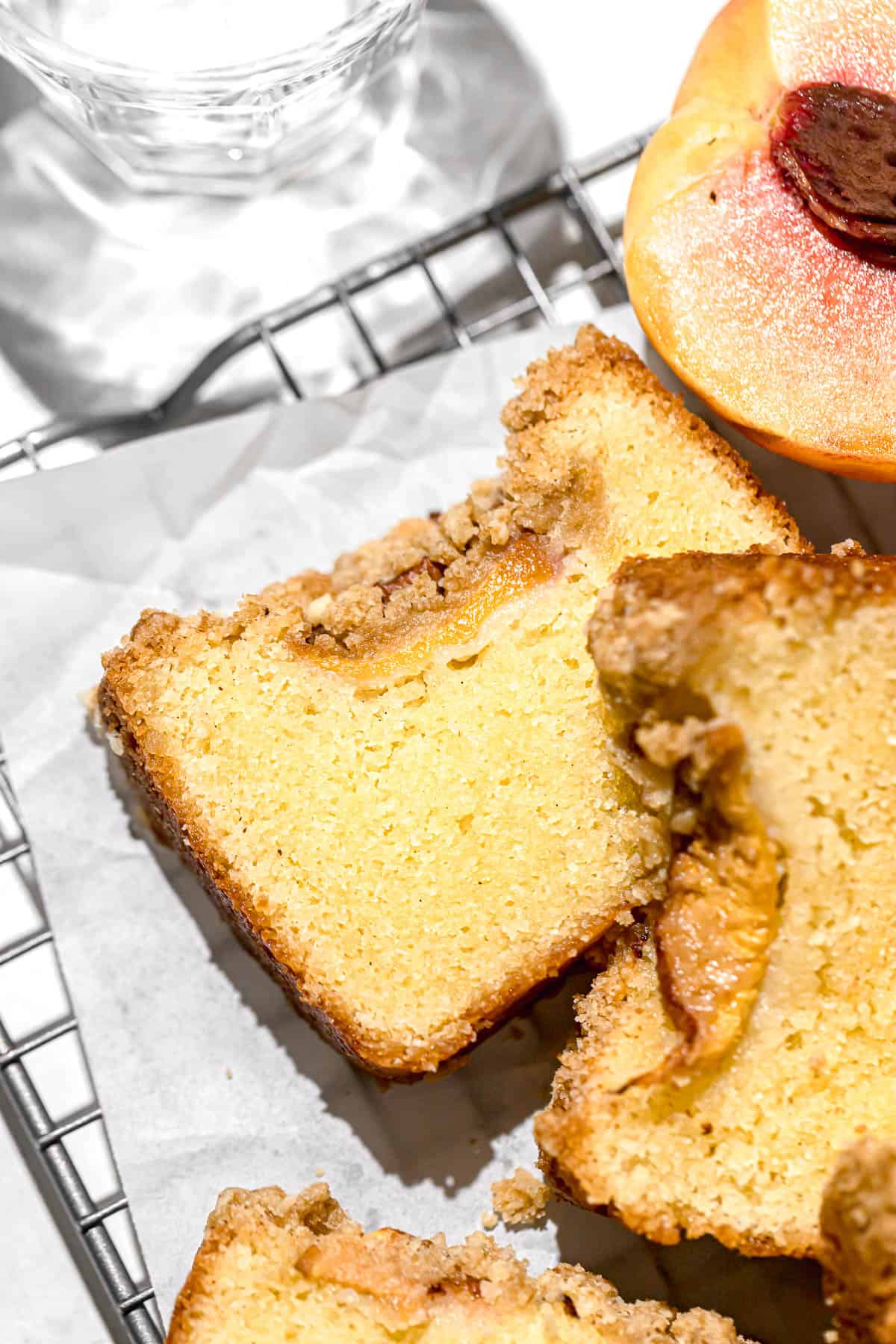 slices of peach cobbler pound cake with fresh peaches.