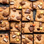 candy bar blondies cut into 16 squares on black tray
