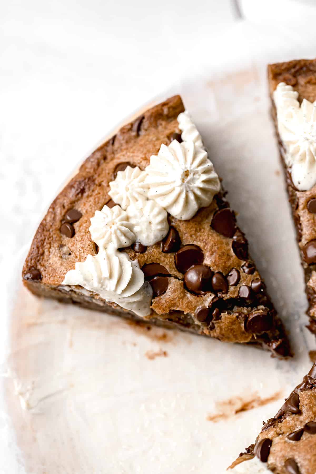 slice of cookie cake on parchment paper.