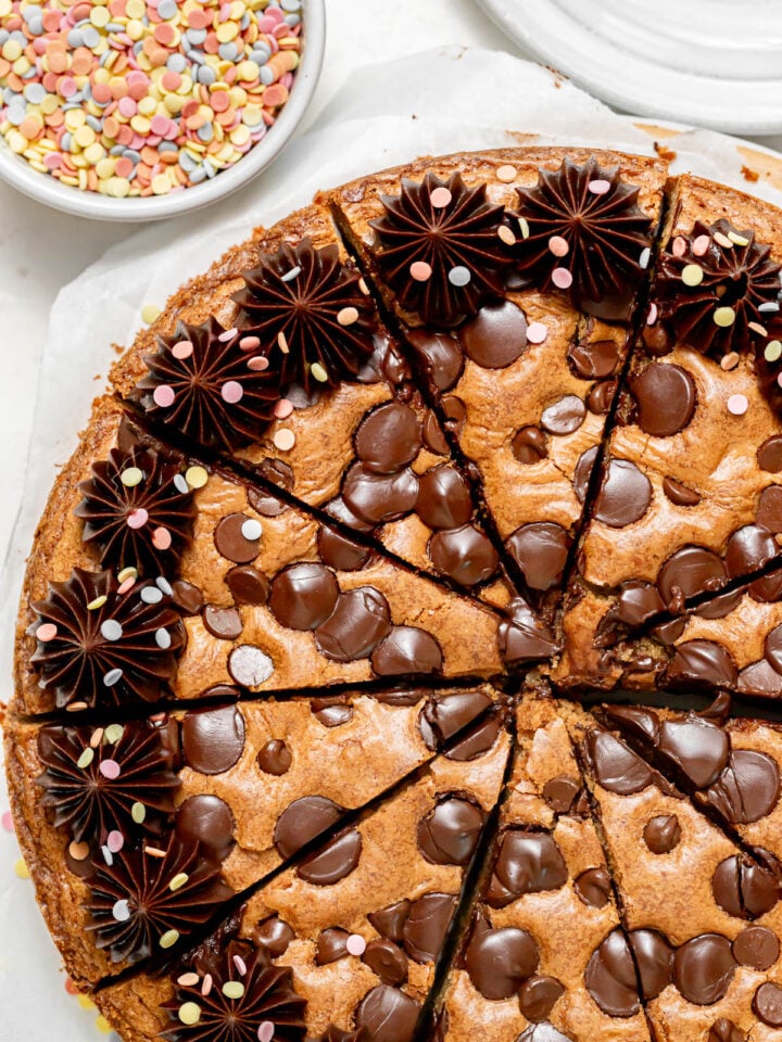 chocolate chip cookie cake cut into individual slices.