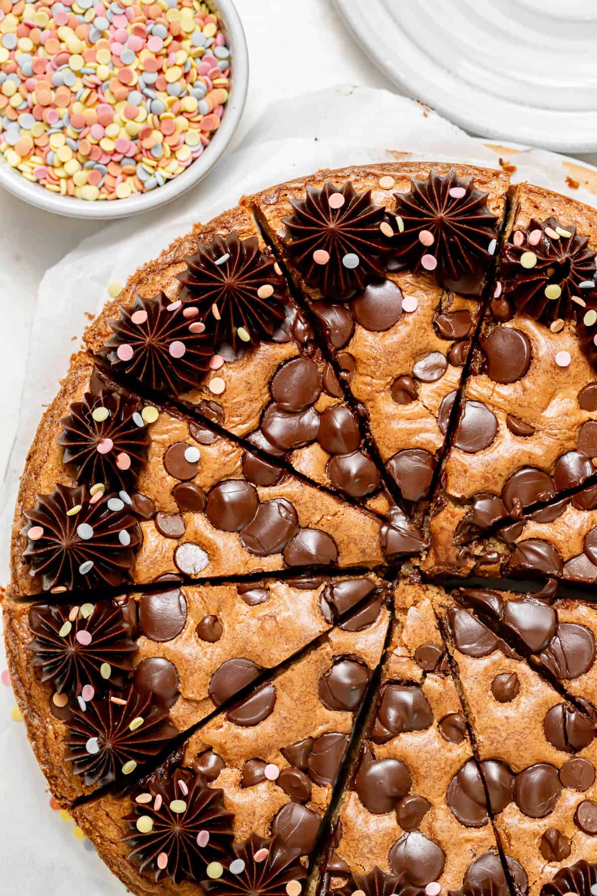 chocolate chip cookie cake cut into individual slices.