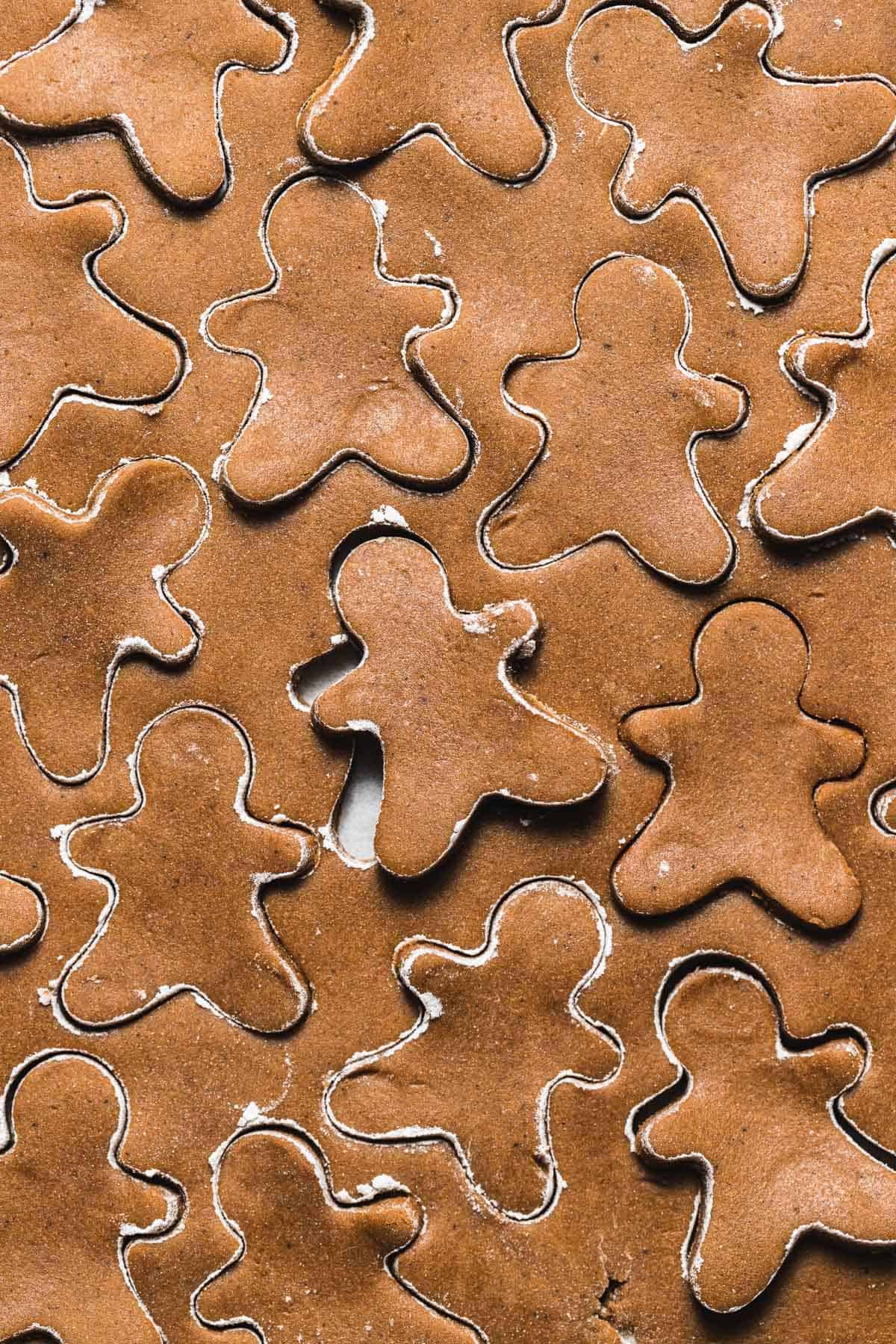 gingerbread cookie dough rolled out and cut out with mini cookie cutters.