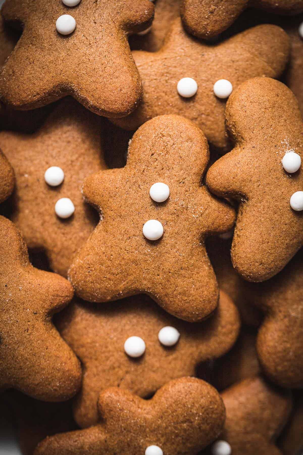 mini gingerbread men cookies in a pile.
