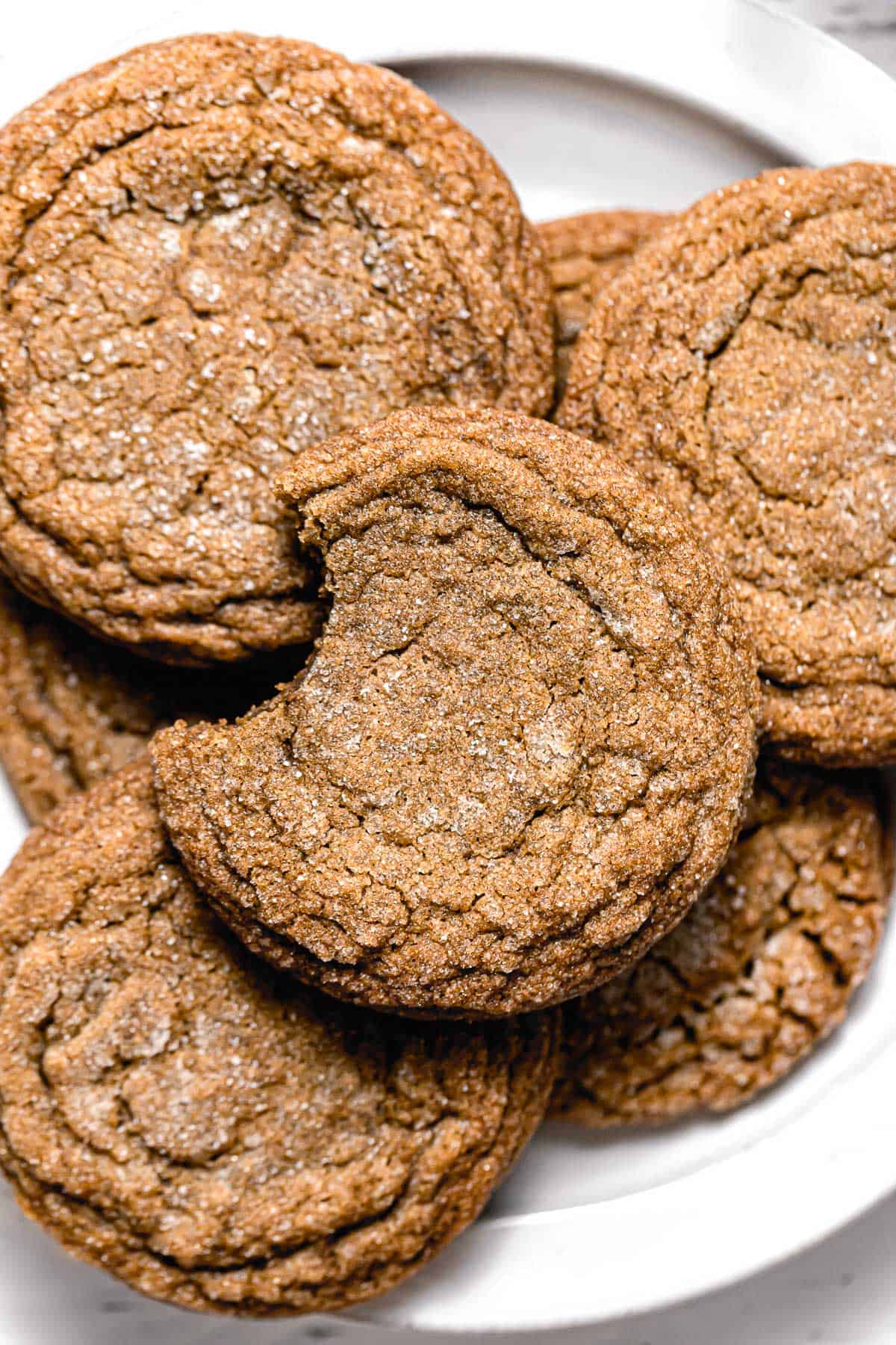 molasses cookies in a pile on plate.