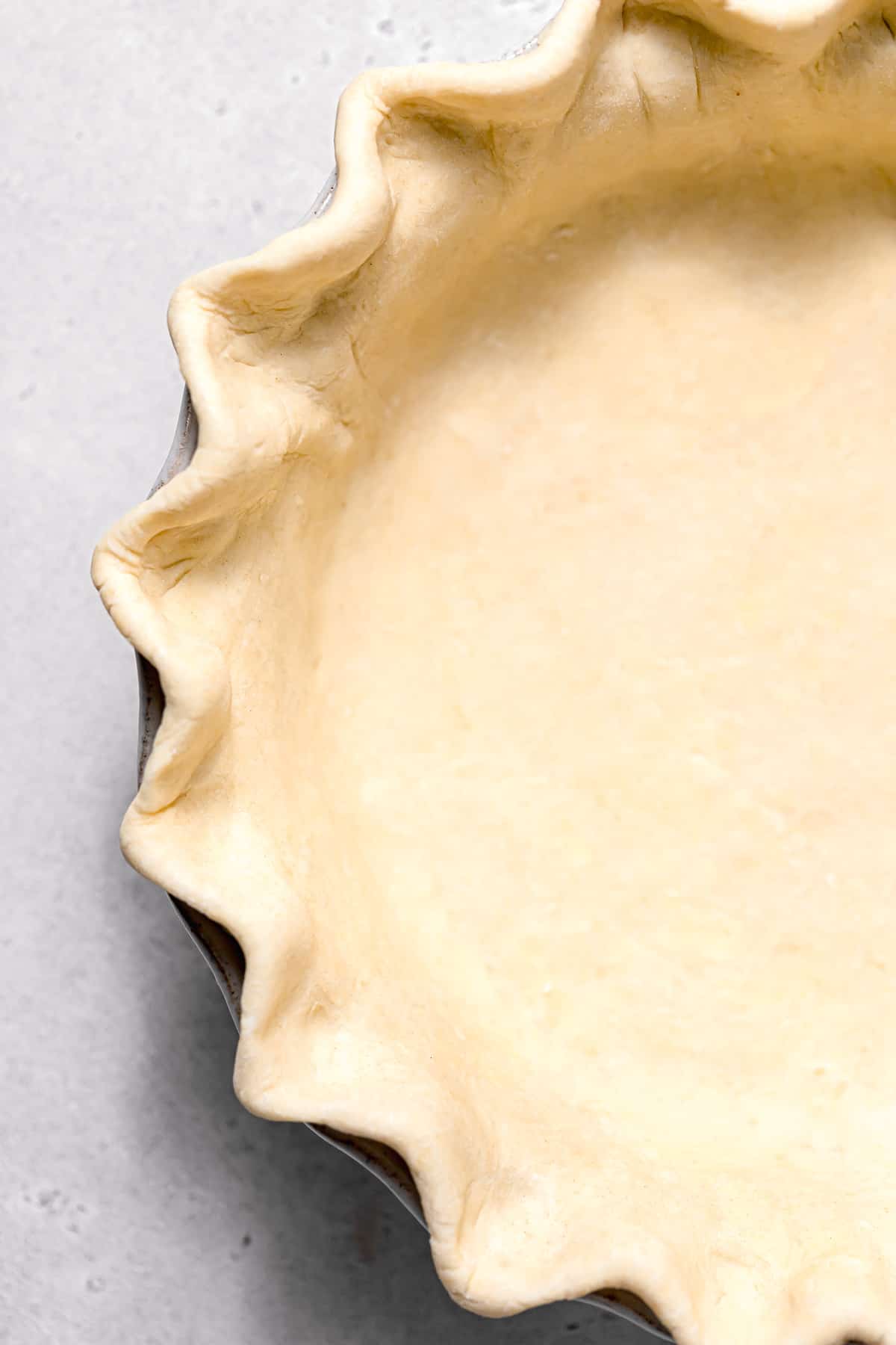 pie dough in pan crimped