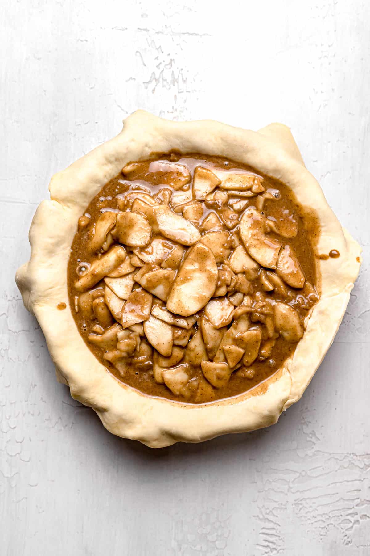 apple pie filling poured in bottom pie crust
