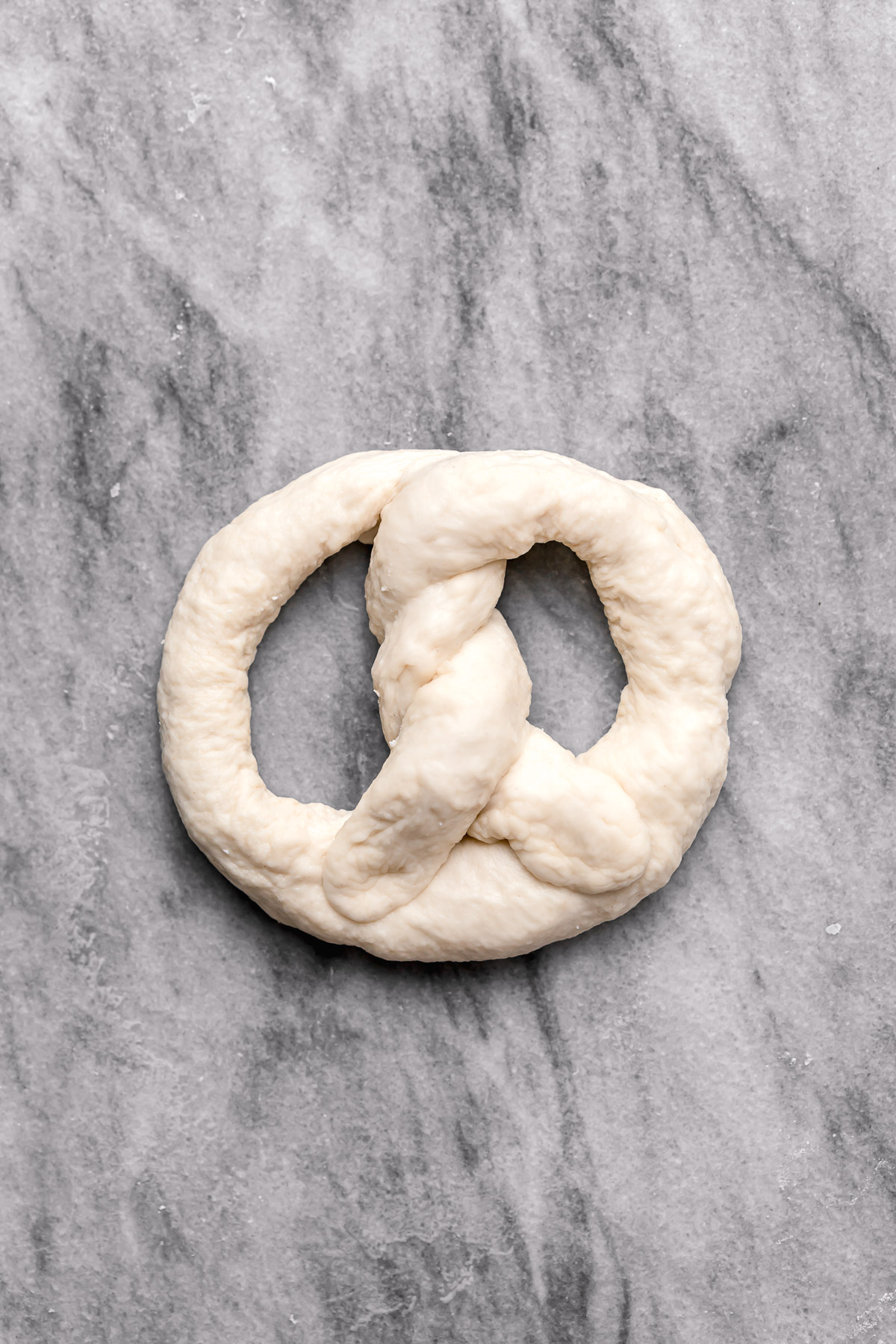 shaped, uncooked soft pretzel dough.