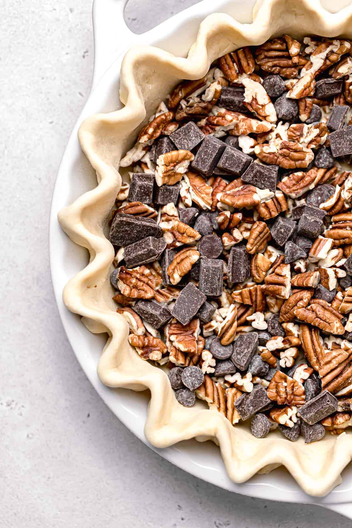 pecans and chocolate chips in pie dough.