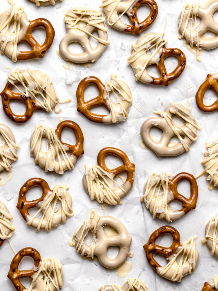 white chocolate covered pretzels on parchment paper
