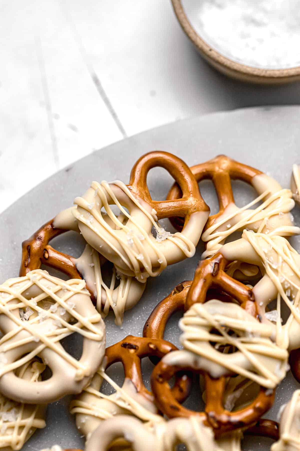 white chocolate covered pretzels on marble tray.