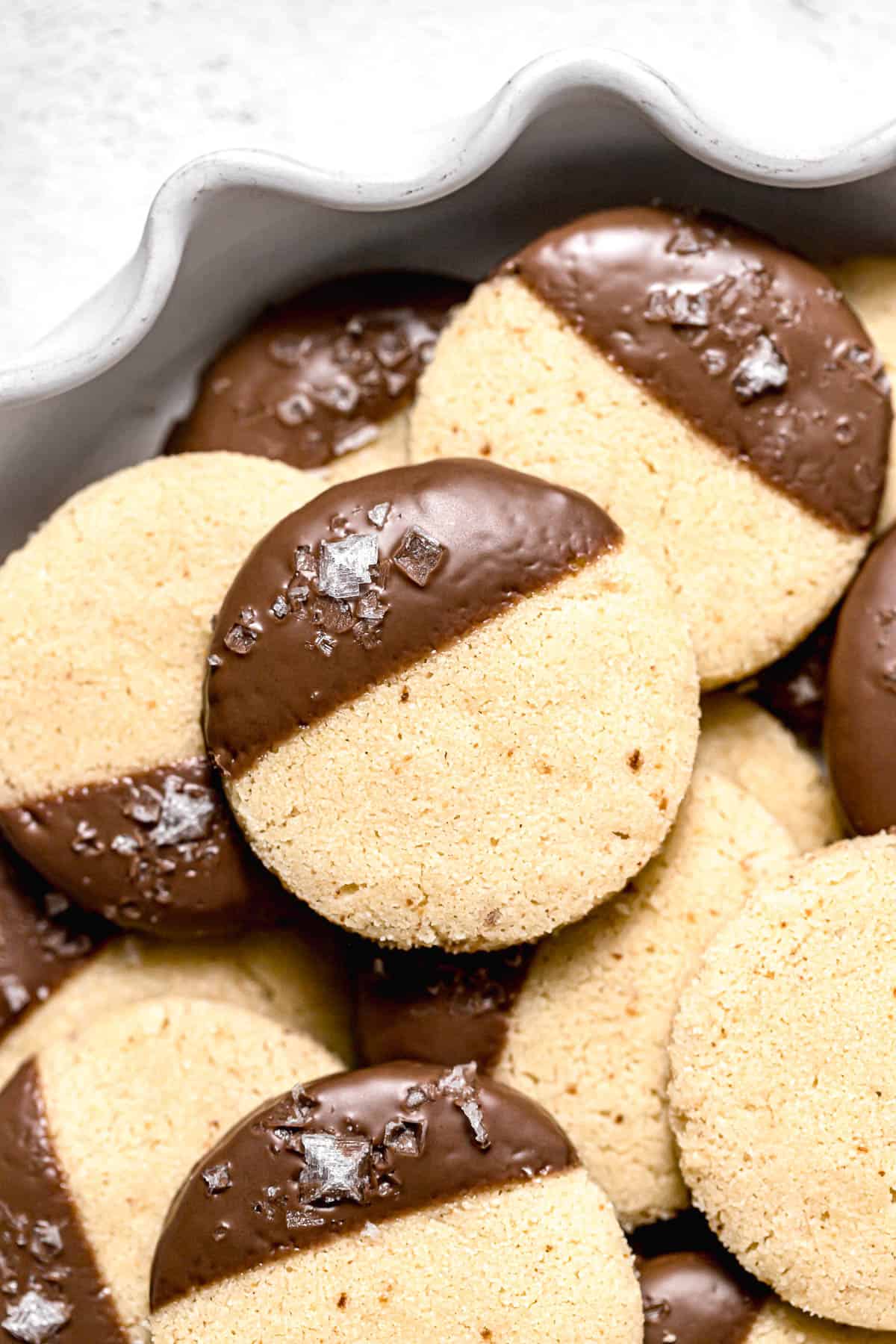 chocolate dipped shortbread cookies in white bowl