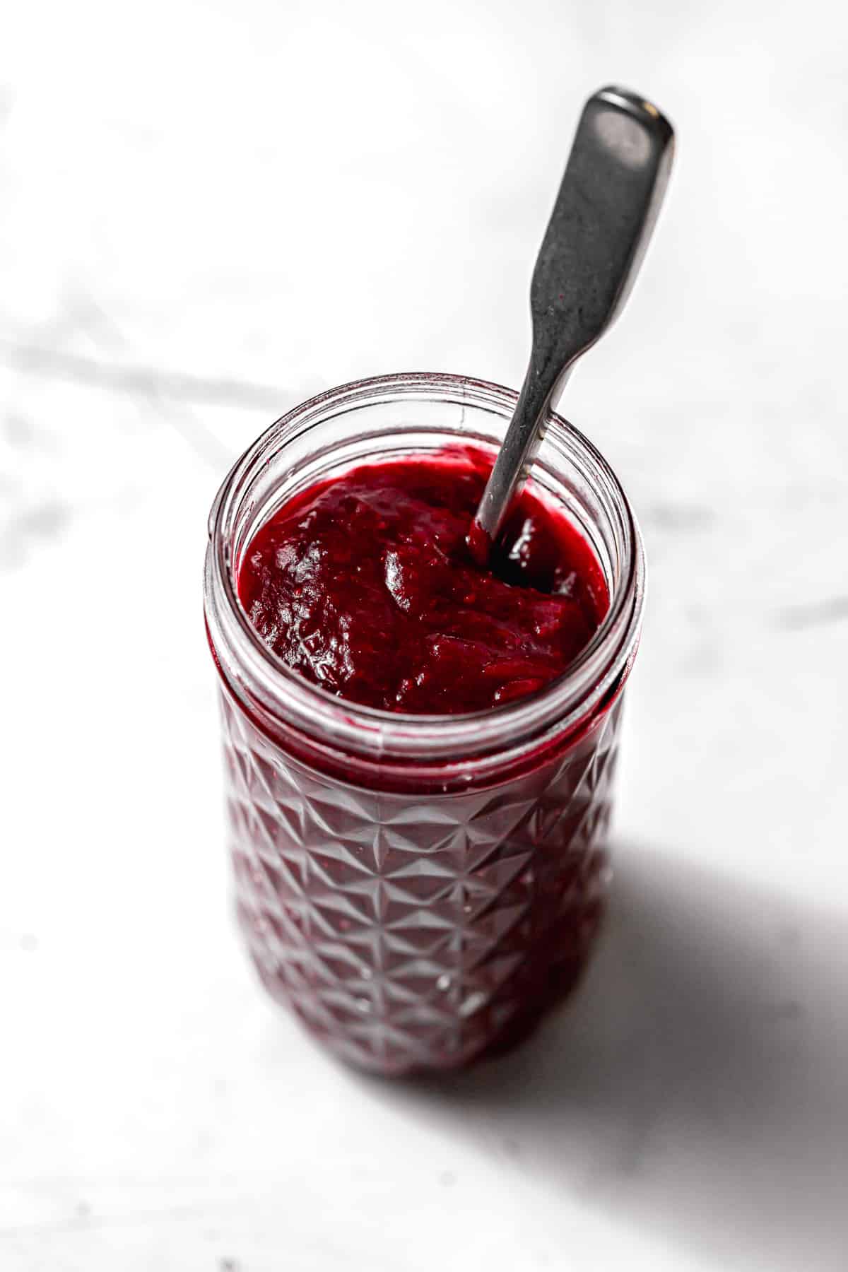 cranberry jam in glass jar.
