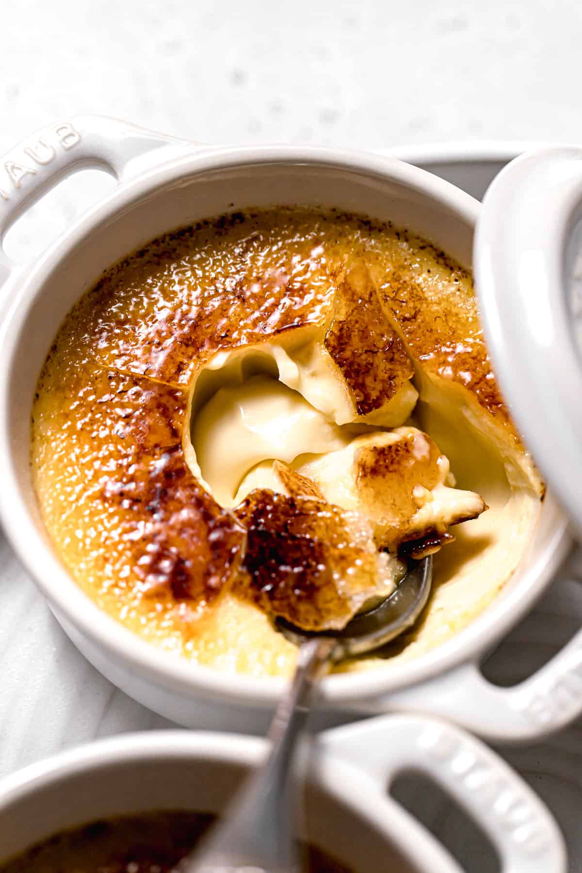 closeup of truffle creme brulee broken open with a spoon