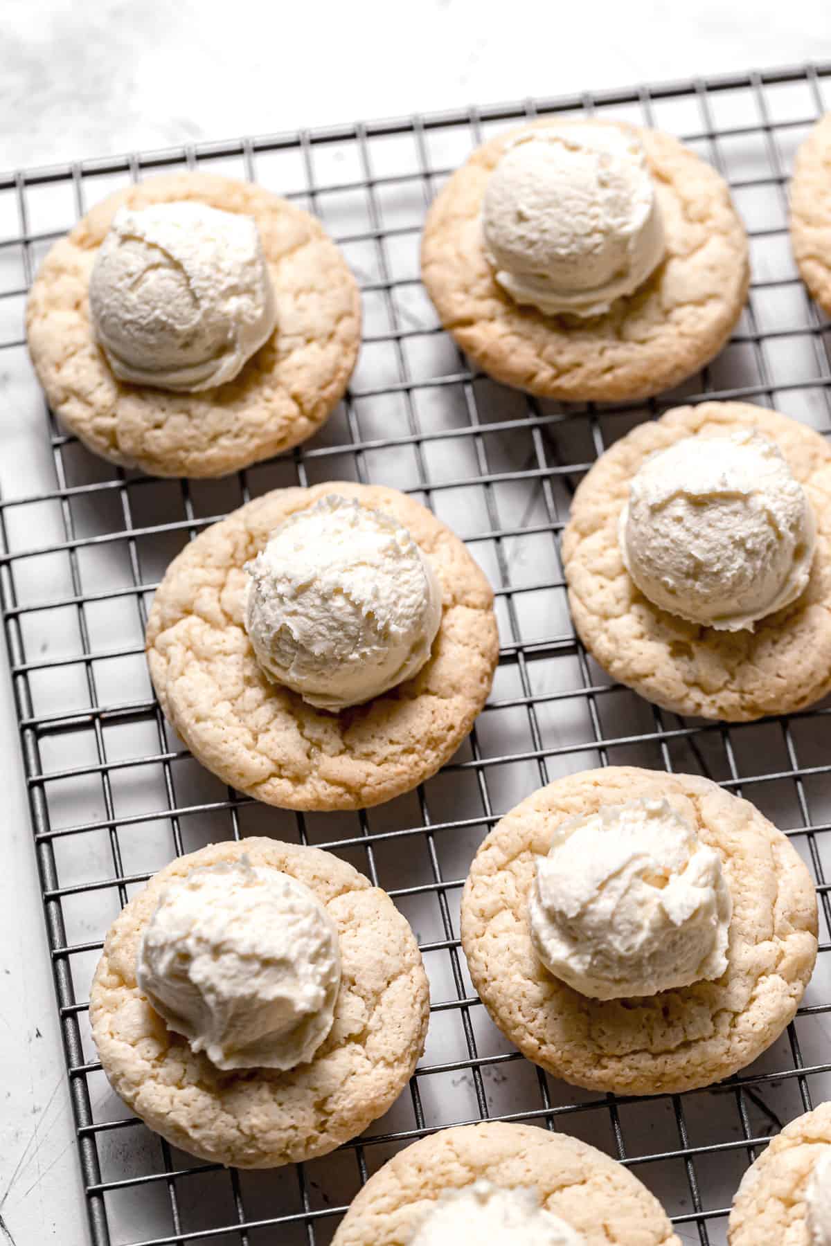 cookies with scoops of buttercream on each.