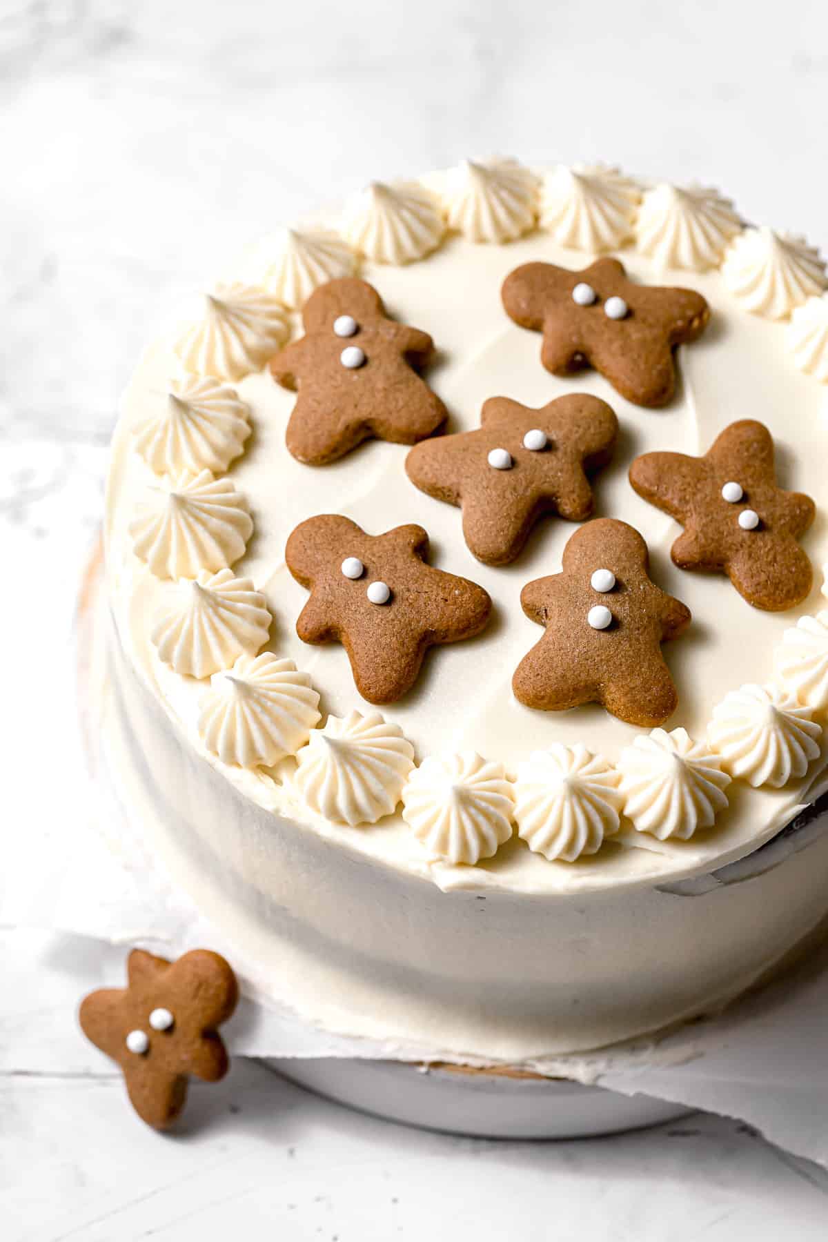 gingerbread cake with cream cheese frosting decorated with mini gingerbread men.