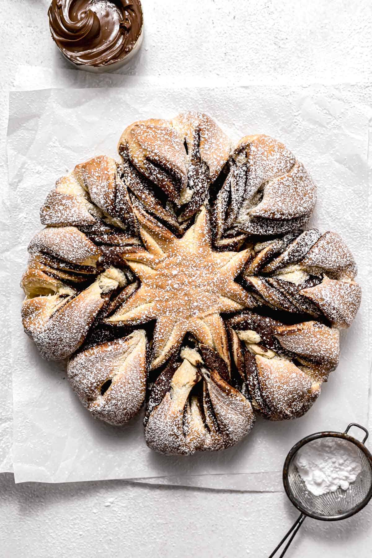 baked nutella star bread topped with powdered sugar.