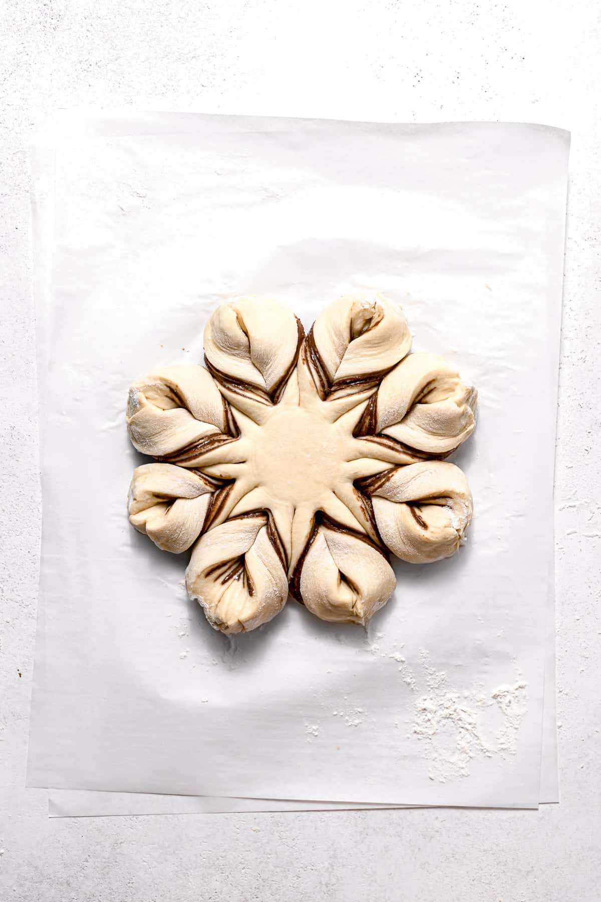shaped star bread on parchment paper.