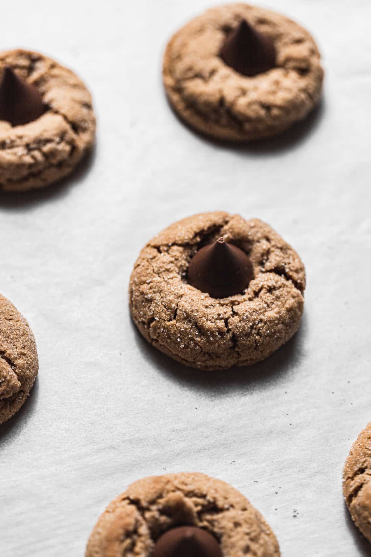 baked peanut butter blossoms on parchment paper.