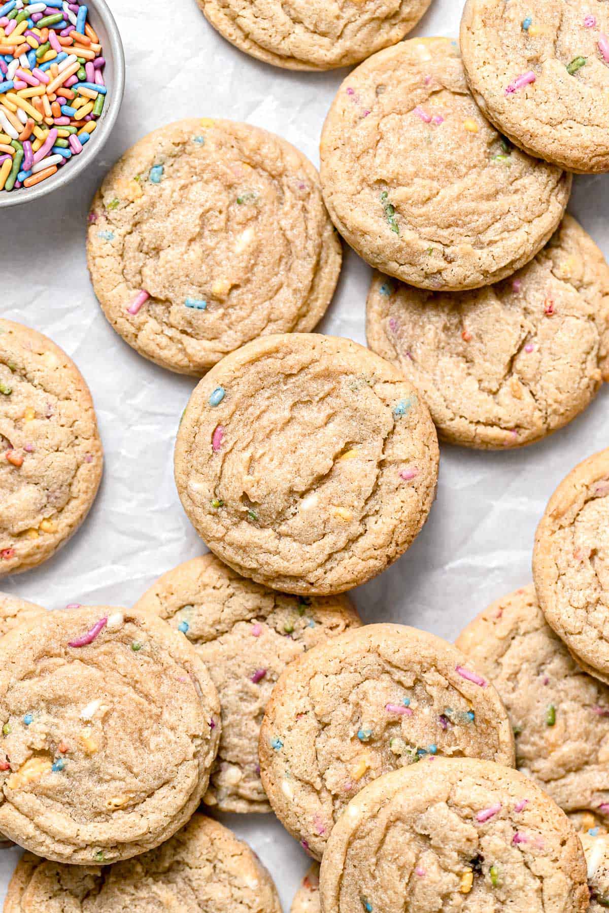 birthday cake cookies piled on parchment paper