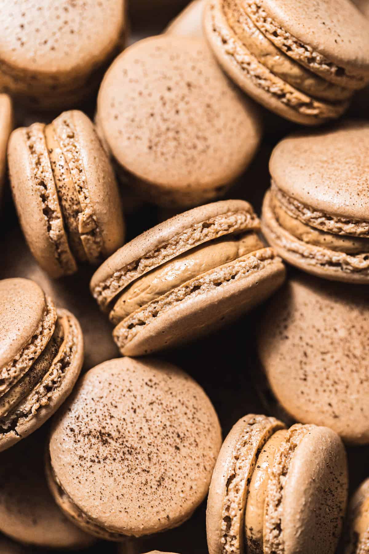 close up of coffee macarons in a pile
