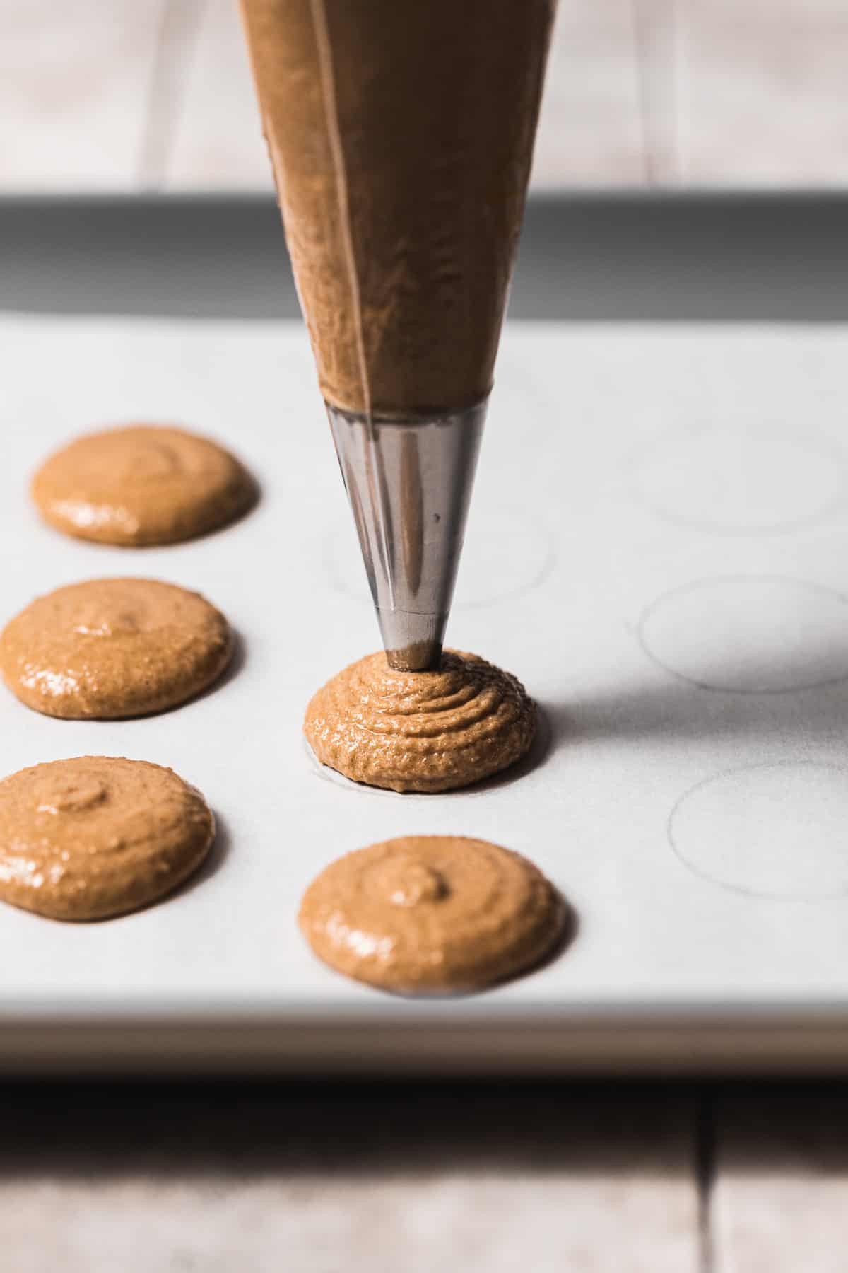 macaron batter being piped