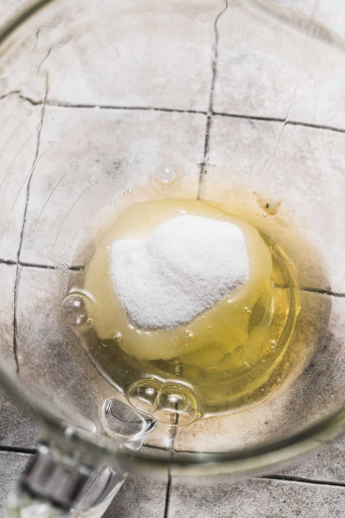 egg whites and sugar in glass bowl
