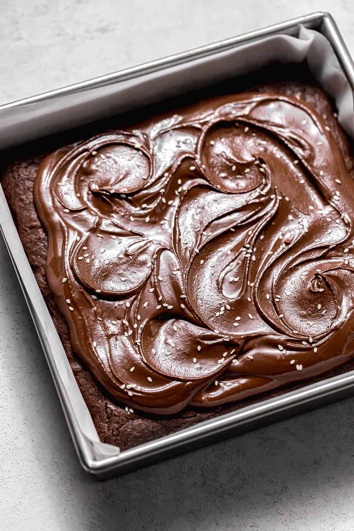 frosted tahini brownies in square pan.