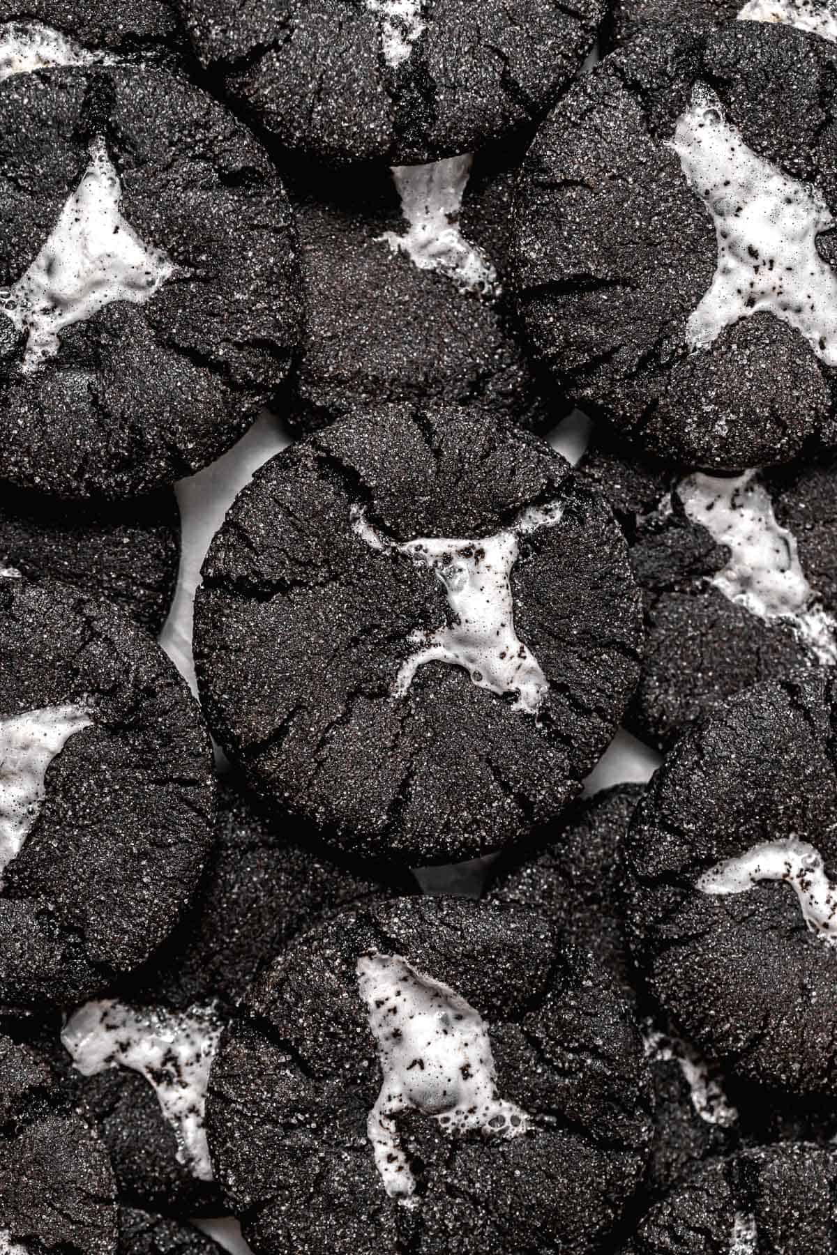 chocolate marshmallow cookies piled on baking sheet.