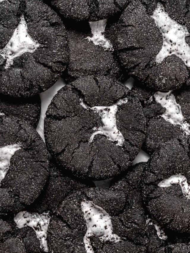 chocolate marshmallow cookies piled on baking sheet