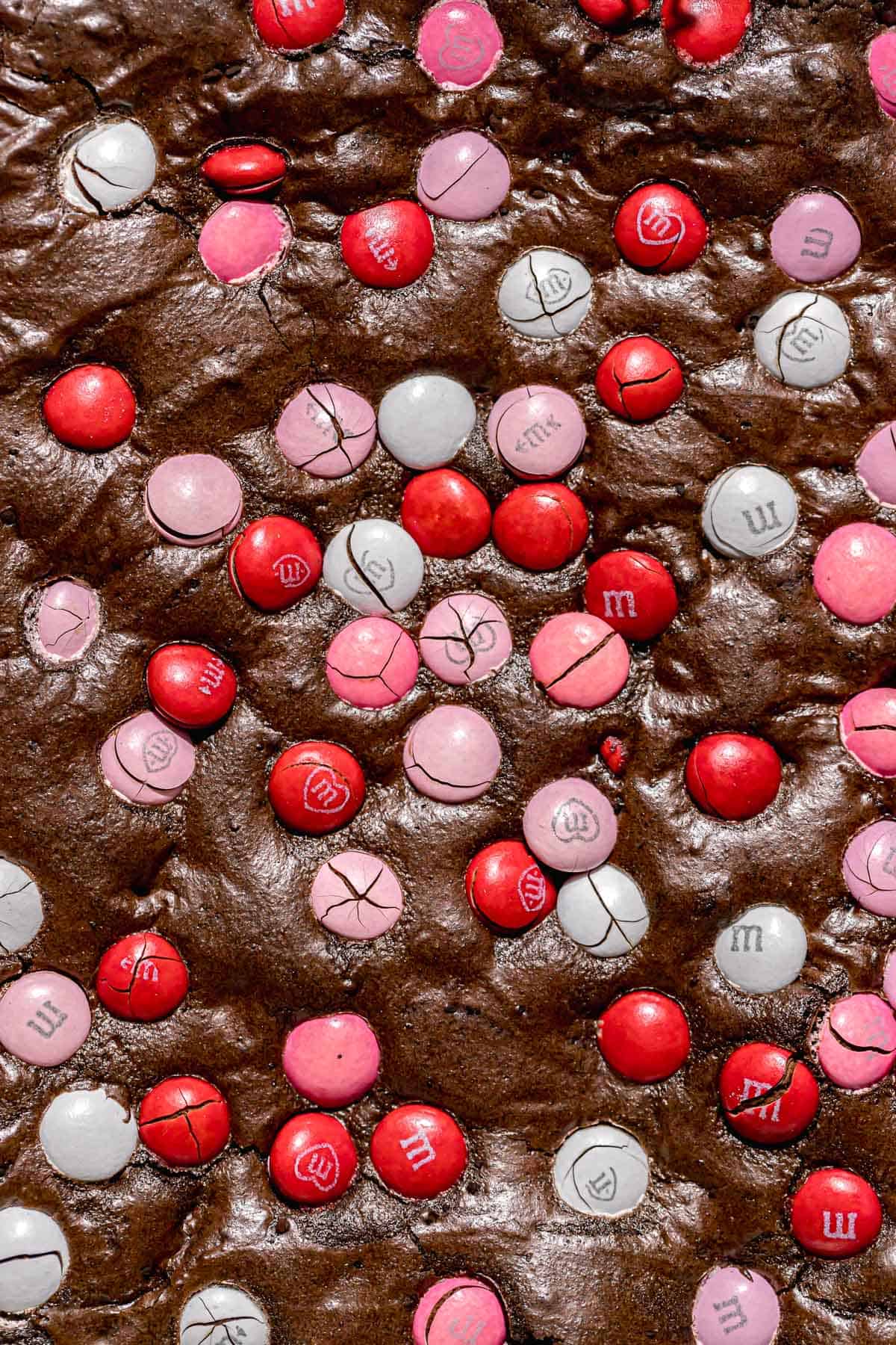 close up of baked brownies with Valentine's M&MS.