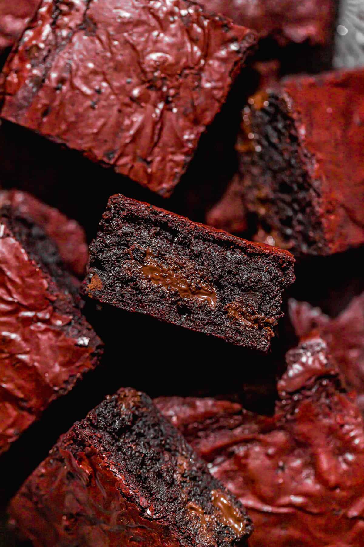 red velvet brownies piled on black tray