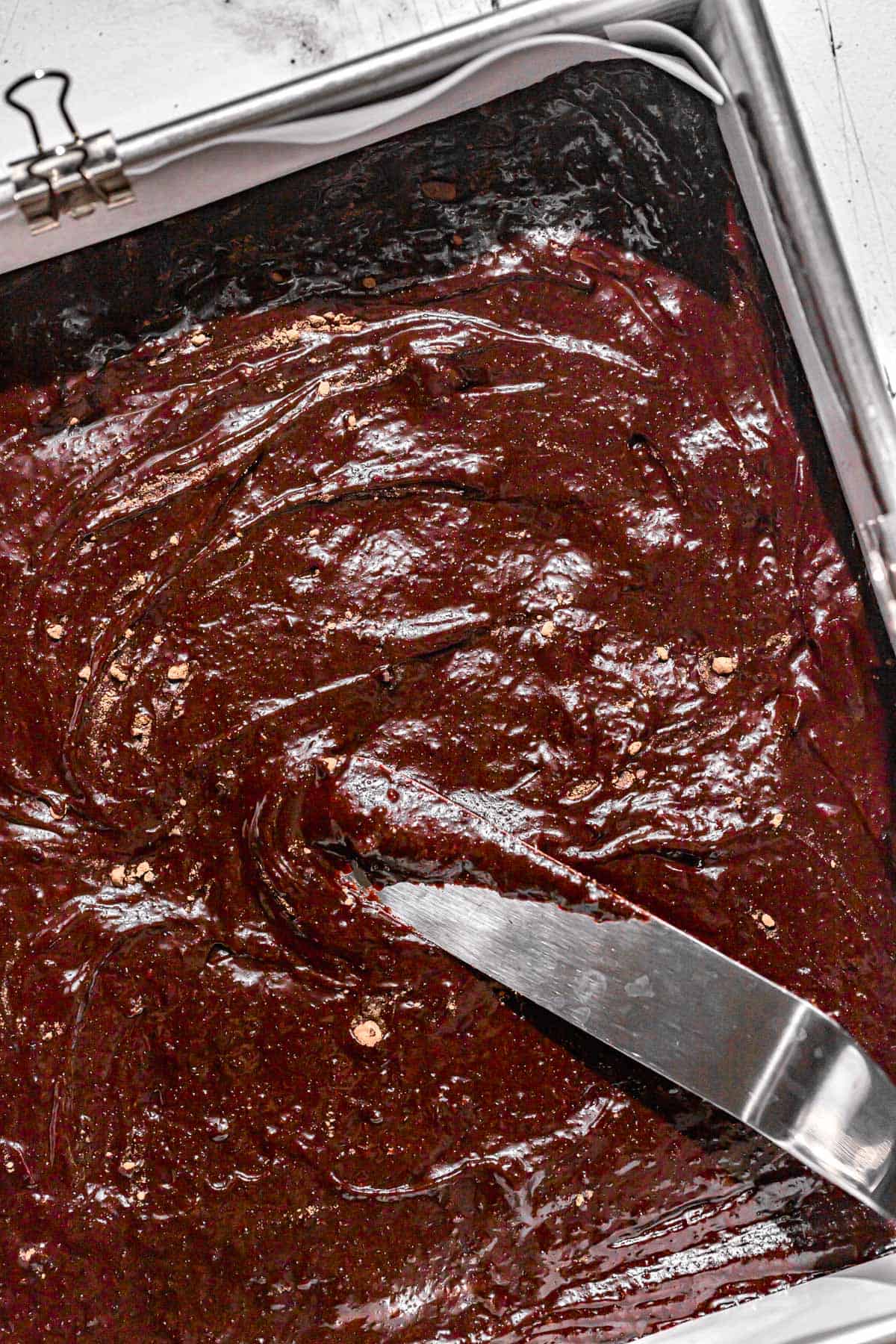 brownie batter added to square pan.